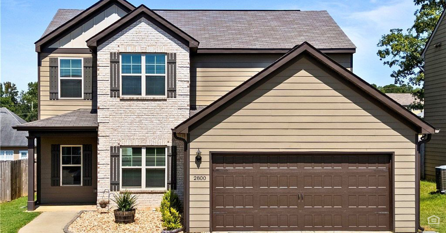 Neighborhood homes feature large garages.
